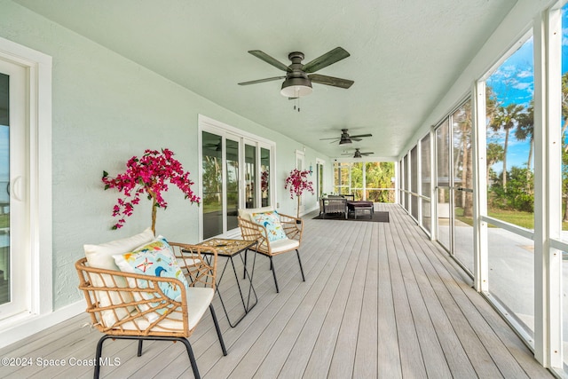 wooden deck featuring ceiling fan