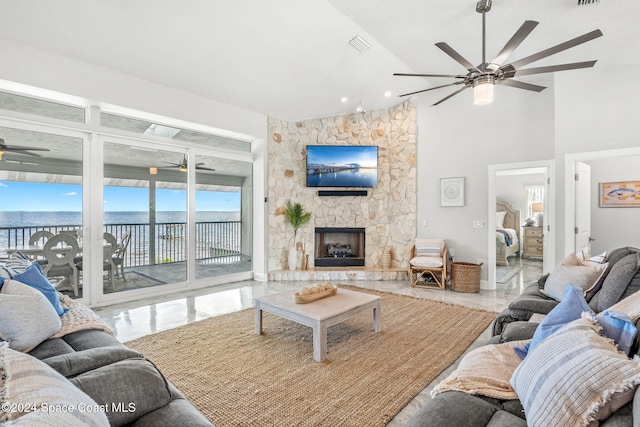 living room featuring ceiling fan and a fireplace