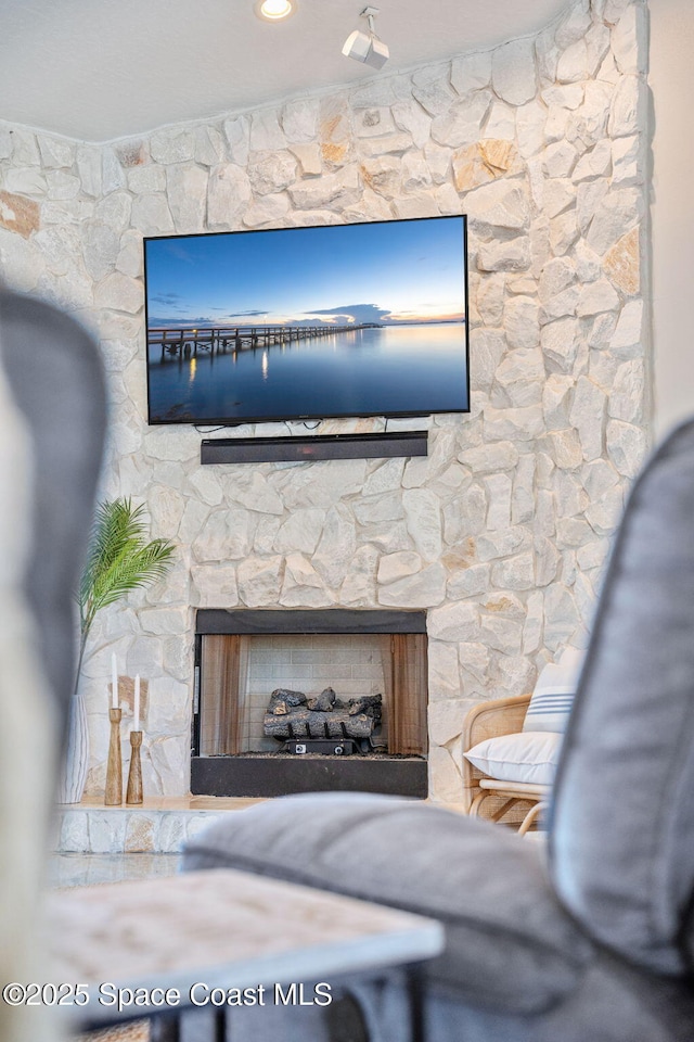 interior details featuring a stone fireplace