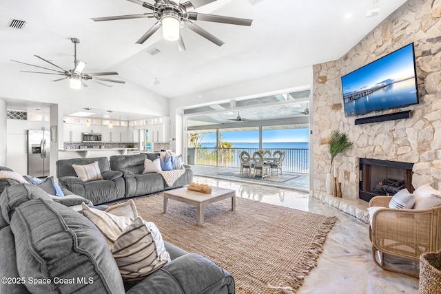 living room with ceiling fan and a fireplace