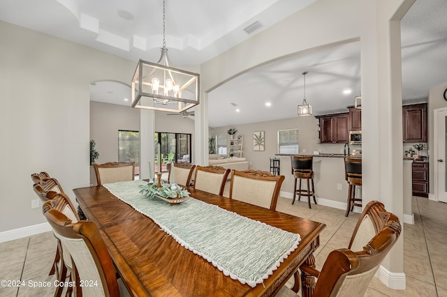 dining room with a notable chandelier and light tile patterned floors