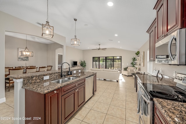 kitchen with sink, lofted ceiling, stainless steel appliances, and hanging light fixtures