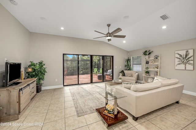 living room featuring lofted ceiling, ceiling fan, and light tile patterned floors