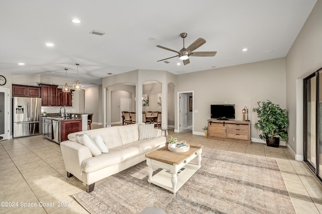 living room with ceiling fan and light tile patterned flooring