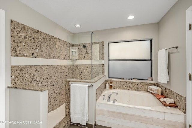 bathroom with shower with separate bathtub