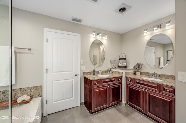 bathroom featuring tile patterned flooring and vanity