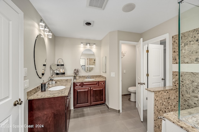 bathroom featuring tile patterned floors, vanity, and toilet