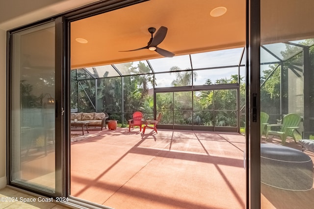 unfurnished sunroom featuring ceiling fan