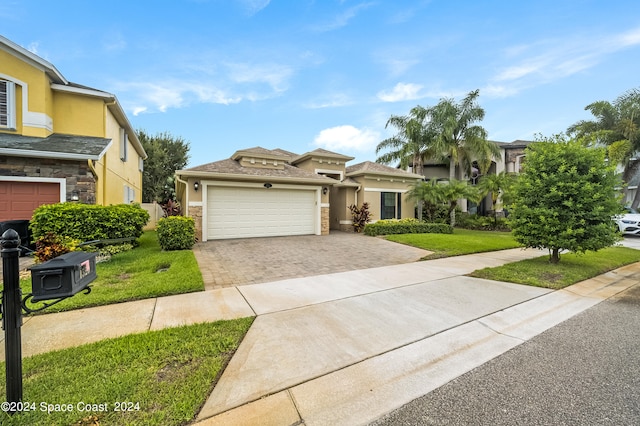 view of front of house featuring a garage and a front lawn