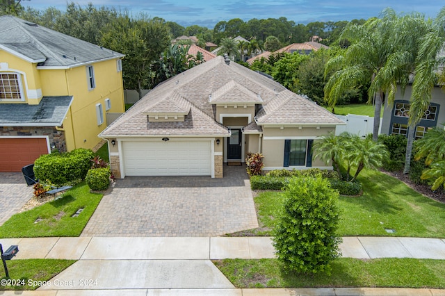 view of front of property with a garage and a front lawn