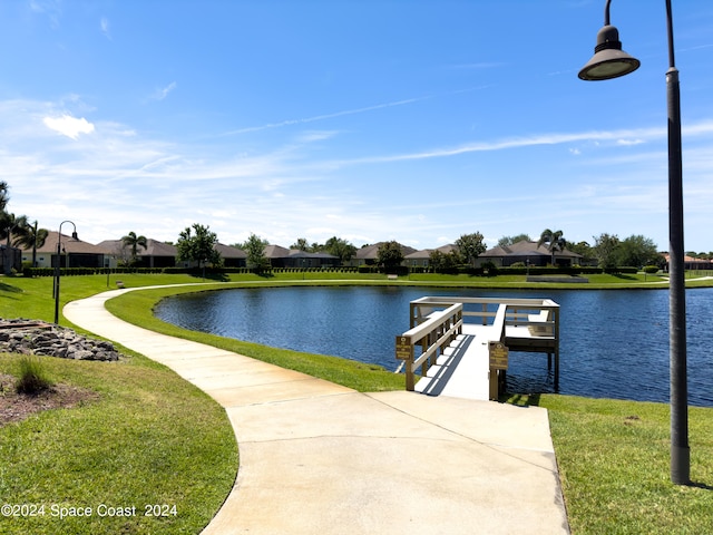 exterior space featuring a water view and a yard