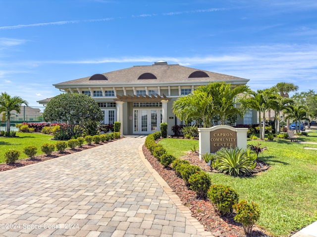 view of front of house with french doors and a front lawn