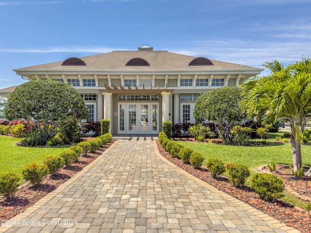 view of front of home featuring french doors and a front lawn