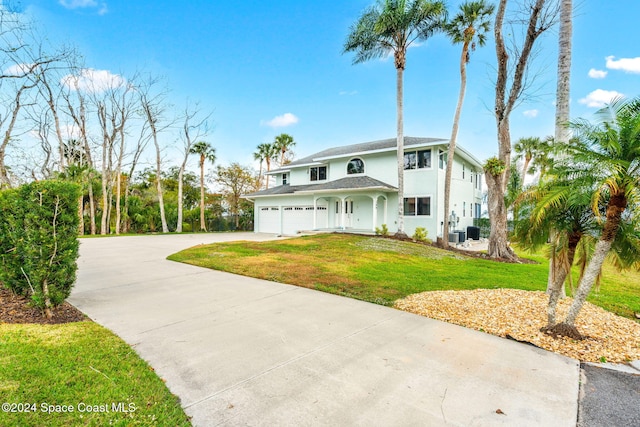 100 Bonita St, Titusville, FL 32780 - traditional-style house with stucco siding, concrete driveway, and a front yard