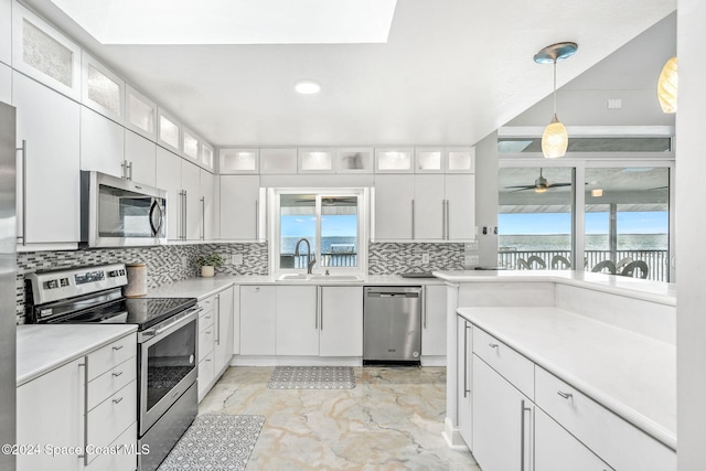 100 Bonita St, Titusville, FL 32780 - kitchen featuring stainless steel appliances, healthy amount of natural light, decorative backsplash, and recessed lighting