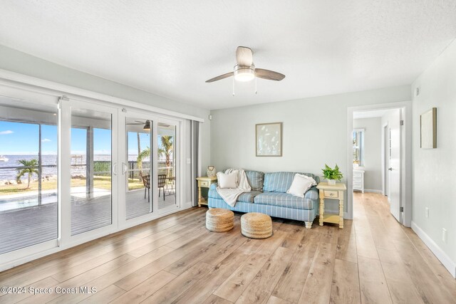 100 Bonita St, Titusville, FL 32780 - living area with ceiling fan, light wood-style flooring, and a water view