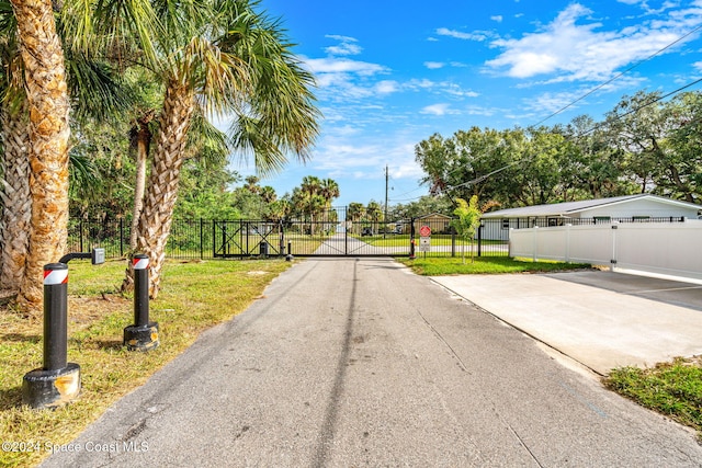 100 Bonita St, Titusville, FL 32780 - view of asphalt road with a gate