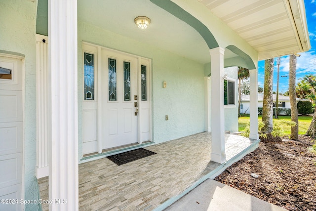 100 Bonita St, Titusville, FL 32780 - entrance to property with stucco siding and a porch