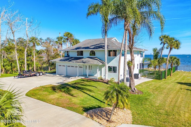 100 Bonita St, Titusville, FL 32780 - traditional home with concrete driveway, stucco siding, a water view, and an attached garage