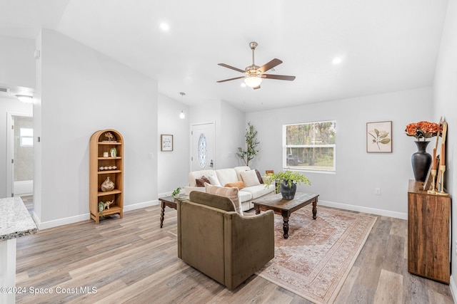 living room featuring ceiling fan and light hardwood / wood-style flooring