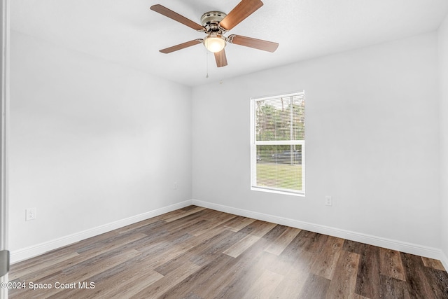 empty room featuring ceiling fan and hardwood / wood-style floors