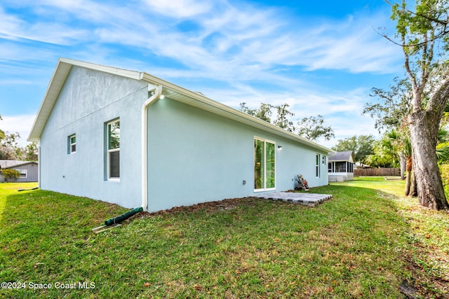 back of house with a lawn