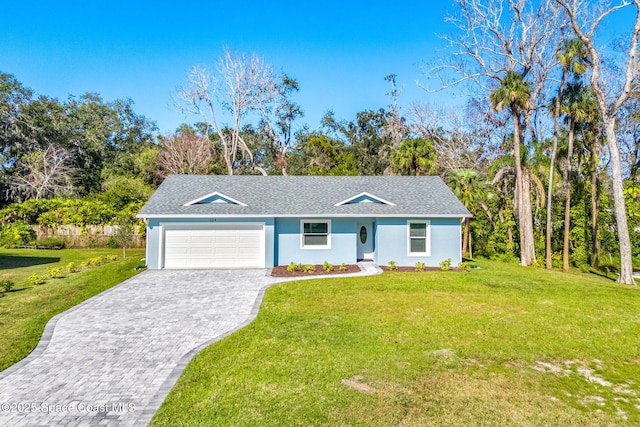 single story home with a garage and a front lawn