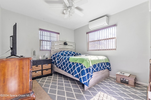 carpeted bedroom with ceiling fan, a wall unit AC, and multiple windows