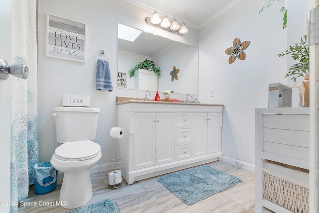 bathroom with crown molding, vanity, and toilet