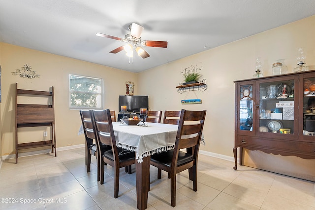 dining space featuring light tile patterned floors and ceiling fan