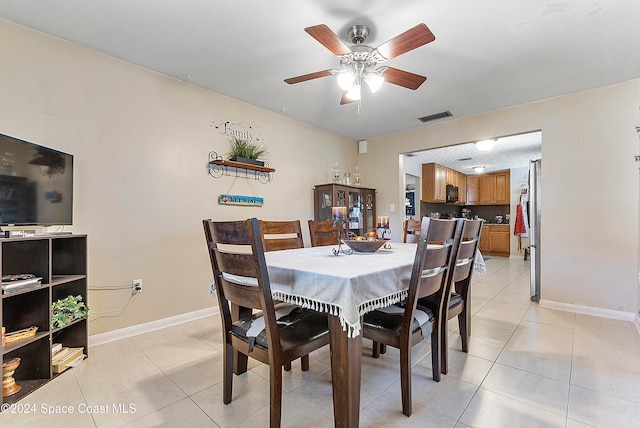 tiled dining area featuring ceiling fan