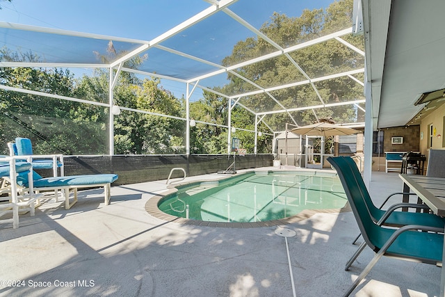 view of pool featuring a lanai, a patio, and a storage shed