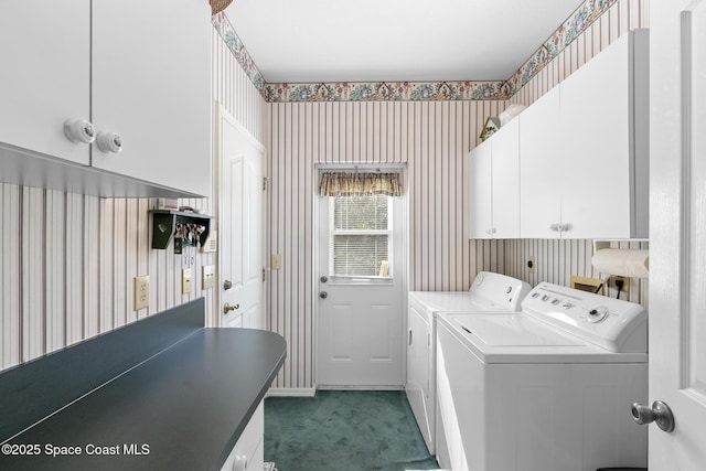 washroom featuring washing machine and dryer, cabinets, and carpet