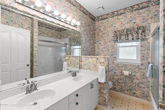 bathroom featuring vanity, toilet, and walk in shower