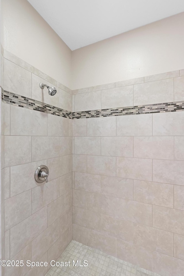 bathroom with a tile shower