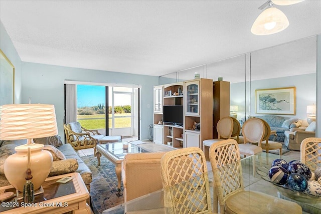 living room with light tile patterned floors and a textured ceiling