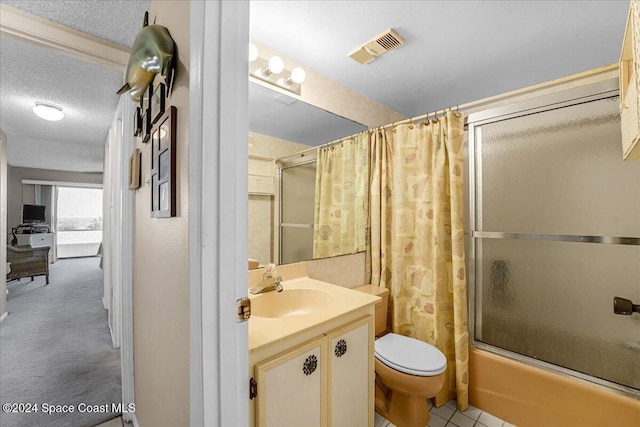 full bathroom with shower / bath combo with shower curtain, vanity, a textured ceiling, and toilet