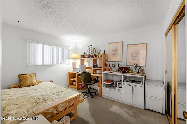 carpeted bedroom with a closet and a textured ceiling