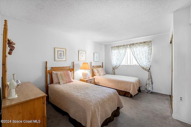 bedroom featuring carpet floors and a textured ceiling