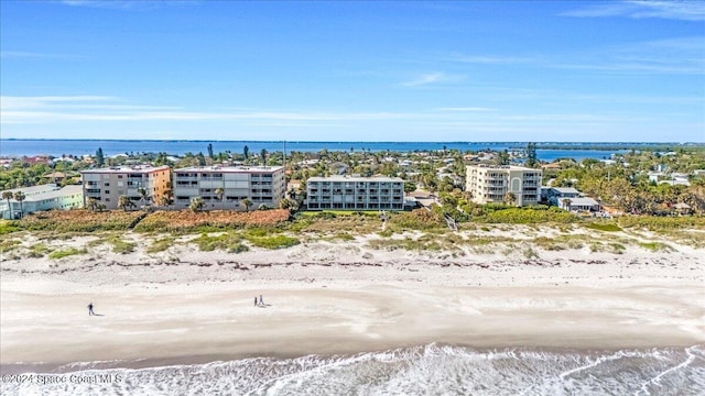 birds eye view of property with a view of the beach and a water view