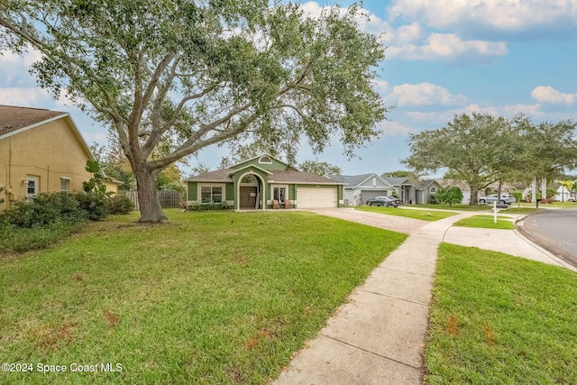 ranch-style home featuring a front lawn and a garage