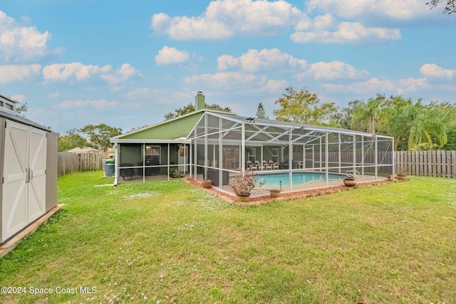 back of house featuring a lawn, glass enclosure, and a fenced in pool