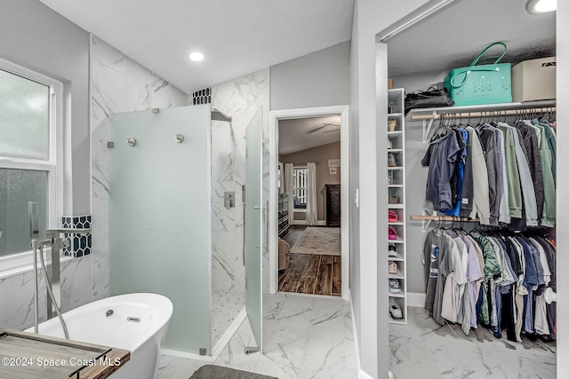 bathroom featuring plus walk in shower and lofted ceiling