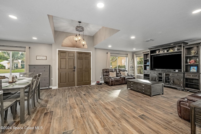 living room featuring hardwood / wood-style floors and an inviting chandelier