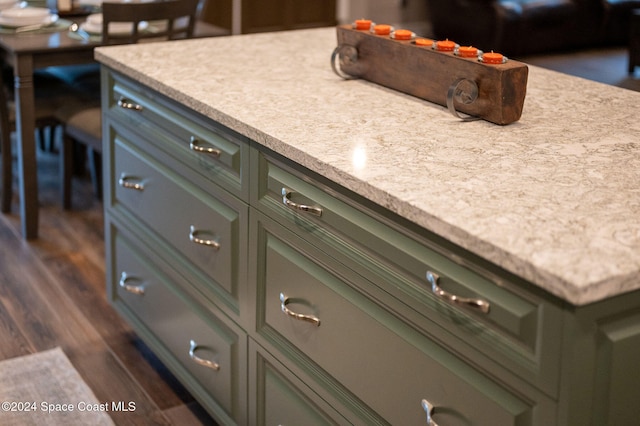 kitchen with dark wood-type flooring and green cabinetry