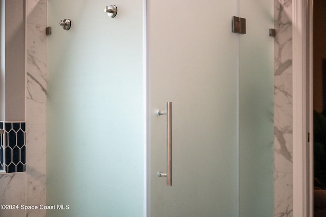 bathroom with a shower with shower door