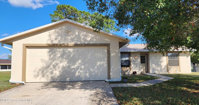 ranch-style home featuring a front lawn and a garage