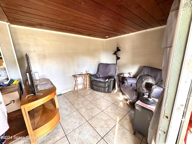 living area with tile patterned floors and wooden ceiling