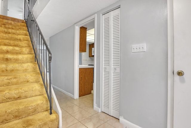 staircase featuring tile patterned flooring