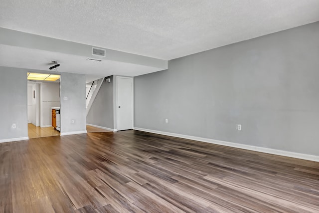 unfurnished living room with a textured ceiling and hardwood / wood-style flooring